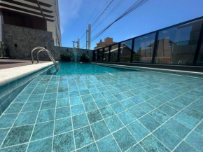 Apartamento em Bombinhas à 70 metros da praia, com piscina aquecida, sala de jogos, academia e espaço kids.